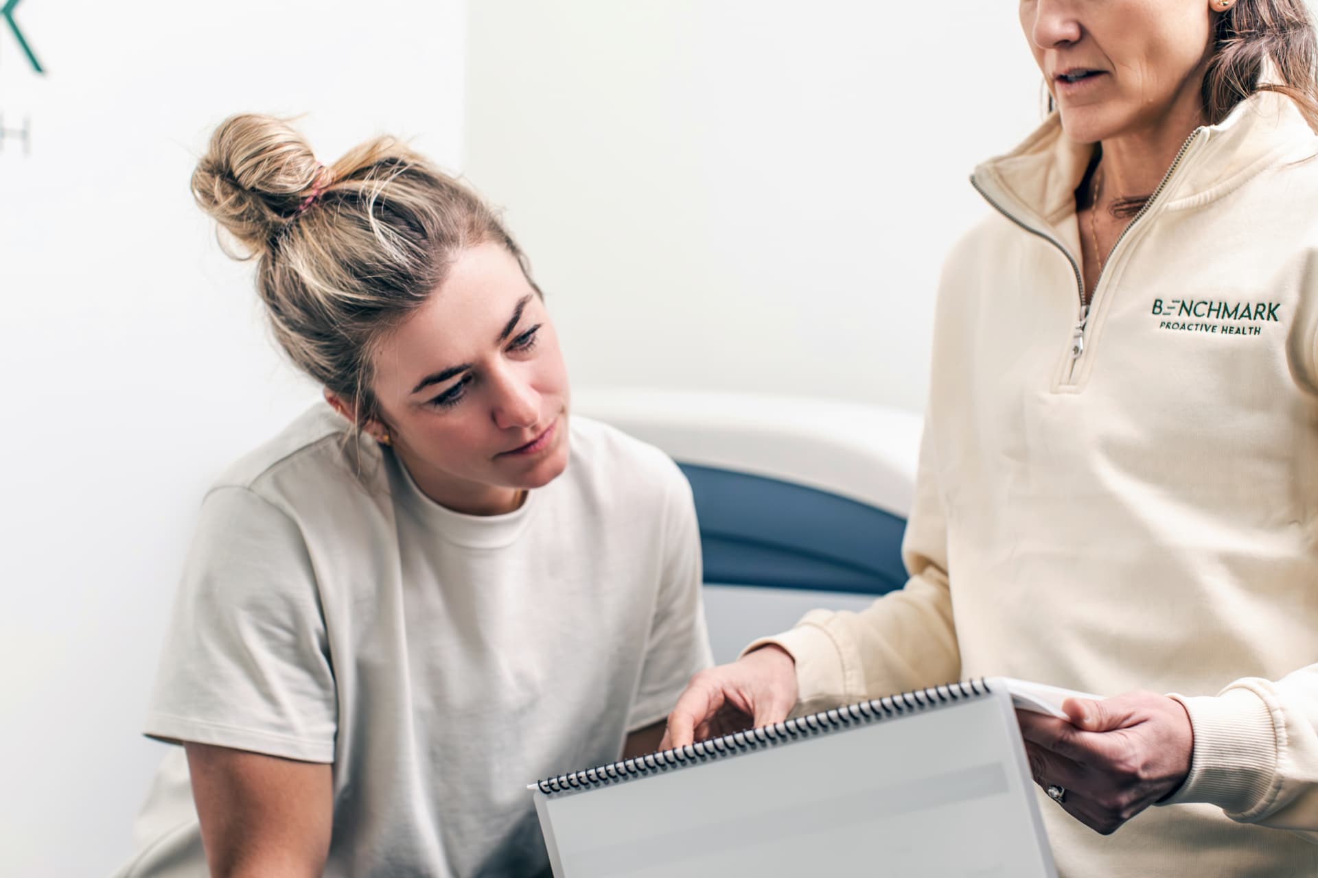 Benchmark clinician reviewing health results with a patient